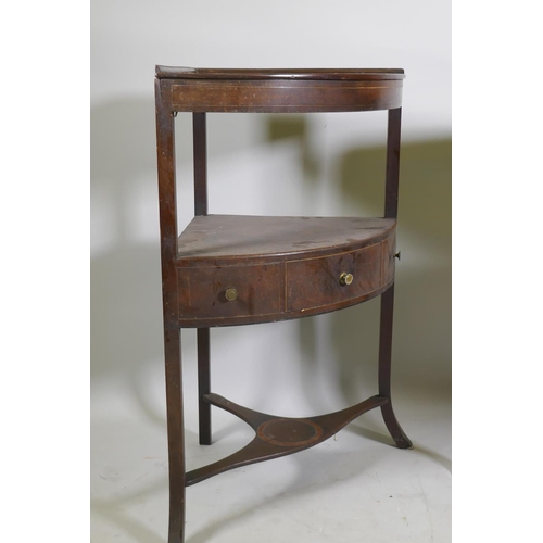 1148 - A Victorian mahogany bow front corner washstand with single cupboard door, raised on sabre supports,... 