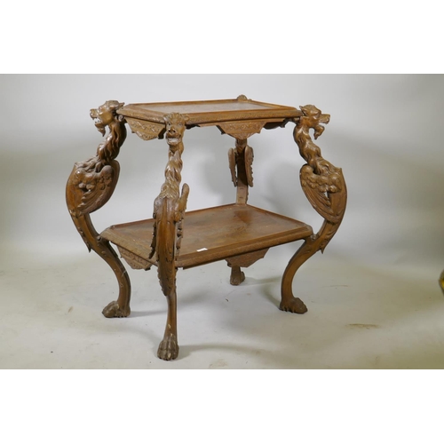 1238 - A C19th Continental walnut two tier etagere, with carved and incised decoration, raised on four wing... 