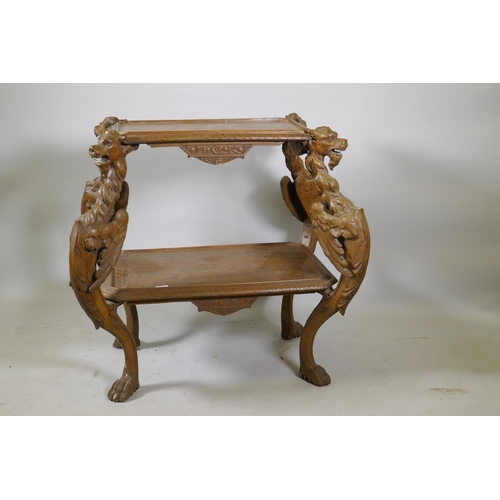 1238 - A C19th Continental walnut two tier etagere, with carved and incised decoration, raised on four wing... 