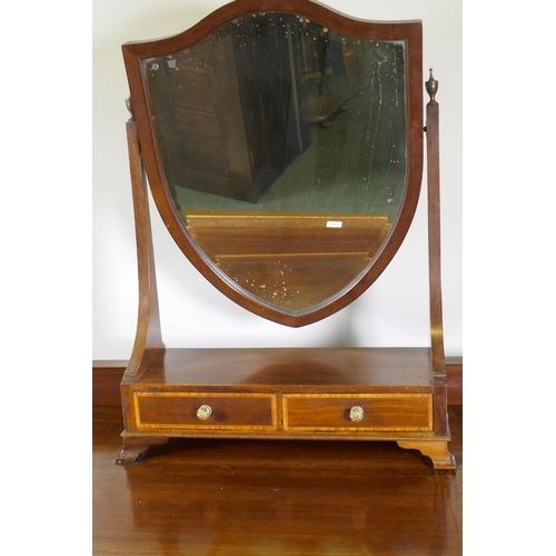 1147 - A mahogany five drawer kneehole dressing table with satinwood banded inlay, raised on tapering suppo... 