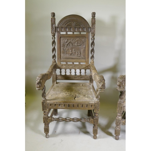 1144 - A pair of antique Continental oak high back hall chairs with carved panel backs and open arms termin... 