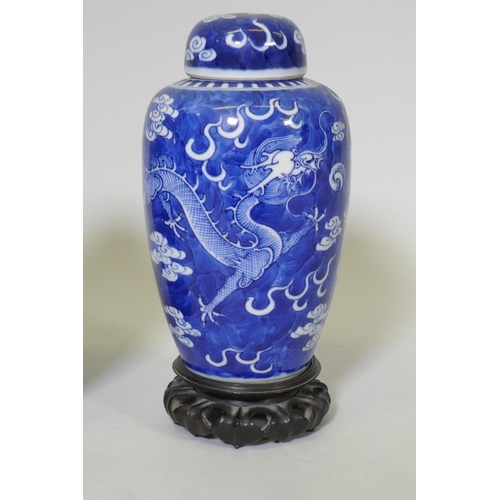 1 - A pair of antique Chinese blue and white dragon jars with covers, KangXi four character mark to base... 