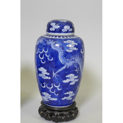 1 - A pair of antique Chinese blue and white dragon jars with covers, KangXi four character mark to base... 