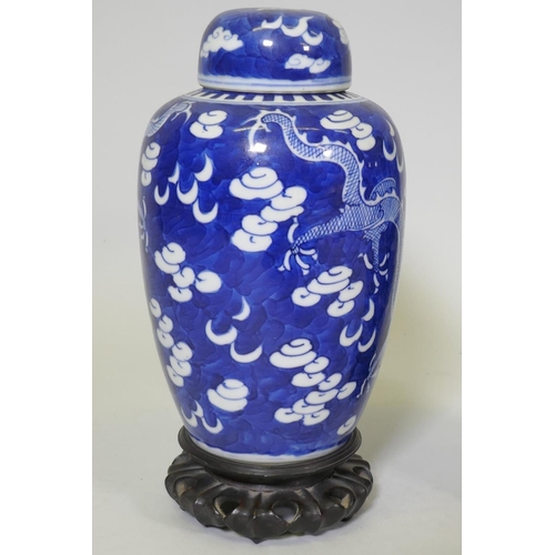 1 - A pair of antique Chinese blue and white dragon jars with covers, KangXi four character mark to base... 