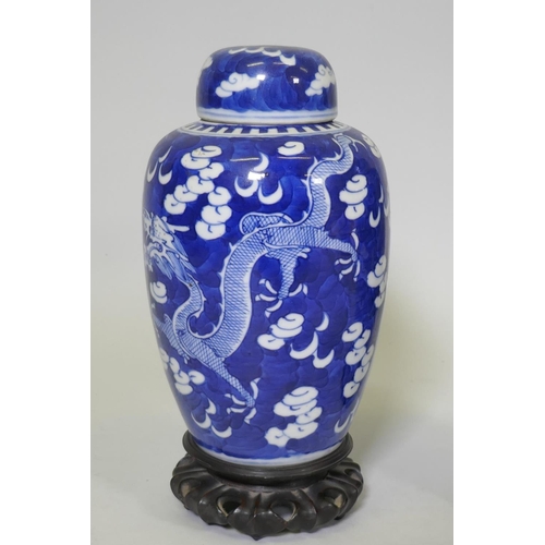 1 - A pair of antique Chinese blue and white dragon jars with covers, KangXi four character mark to base... 