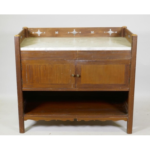 1004 - A C19th mahogany washstand with carrera marble top and three quarter gallery  with gothic style... 