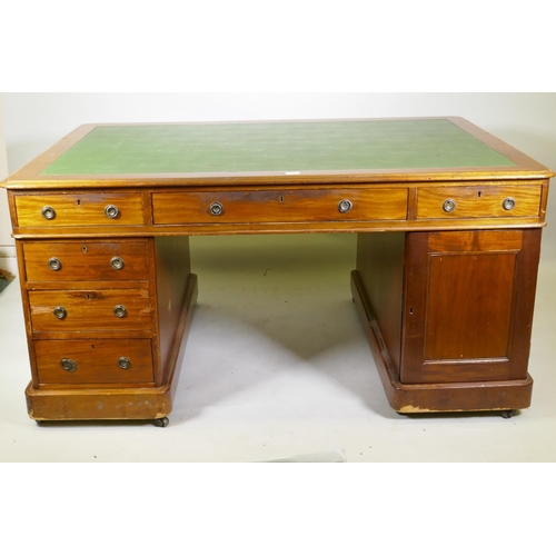 1005 - A Victorian mahogany partners pedestal desk, with twelve drawers and two cupboards, and faux leather... 