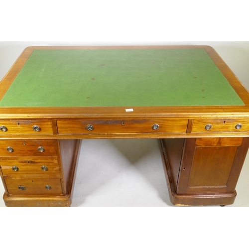 1005 - A Victorian mahogany partners pedestal desk, with twelve drawers and two cupboards, and faux leather... 