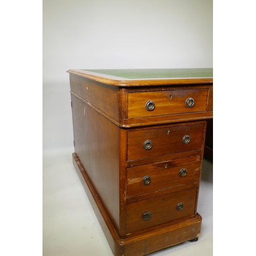 1005 - A Victorian mahogany partners pedestal desk, with twelve drawers and two cupboards, and faux leather... 