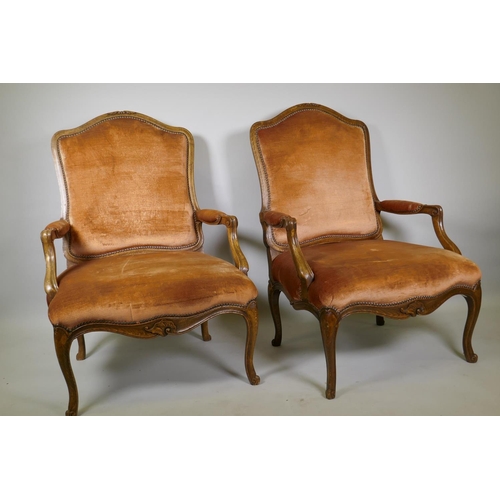 1006 - A pair of beechwood open arm chairs with shaped back in the French style