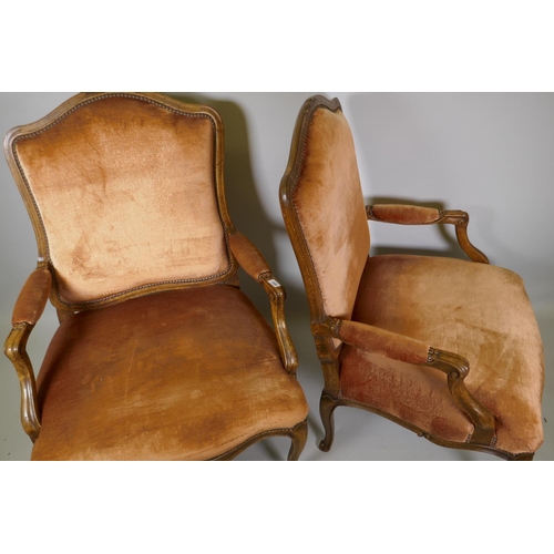 1006 - A pair of beechwood open arm chairs with shaped back in the French style