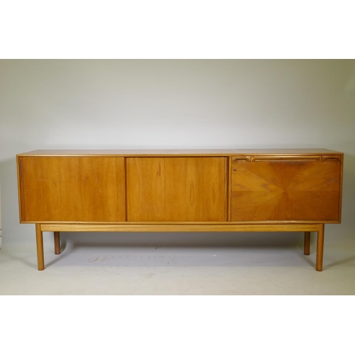 1008 - A McIntosh of Kirkcaldy teak sideboard with slide doors, canteen drawer, fall flap and pull out slid... 