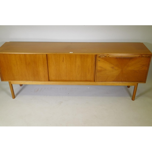 1008 - A McIntosh of Kirkcaldy teak sideboard with slide doors, canteen drawer, fall flap and pull out slid... 