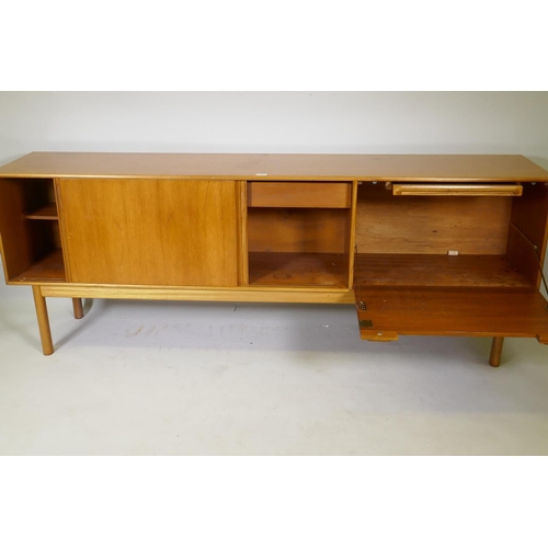 1008 - A McIntosh of Kirkcaldy teak sideboard with slide doors, canteen drawer, fall flap and pull out slid... 