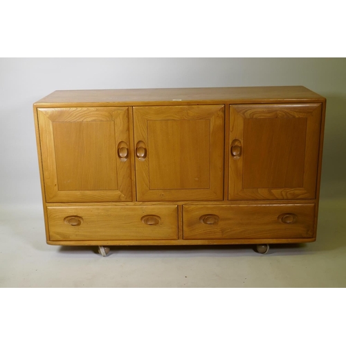 1026 - A mid C20th Ercol elm Windsor sideboard, Model 468, 129 x 44cm, 76cm high