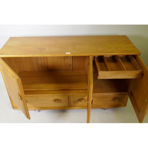 1026 - A mid C20th Ercol elm Windsor sideboard, Model 468, 129 x 44cm, 76cm high