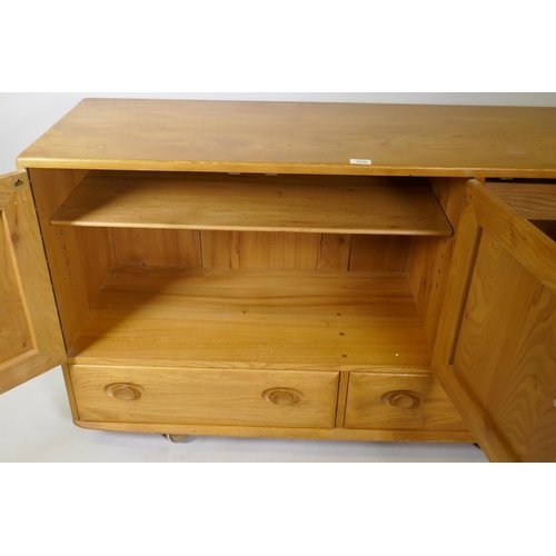 1026 - A mid C20th Ercol elm Windsor sideboard, Model 468, 129 x 44cm, 76cm high