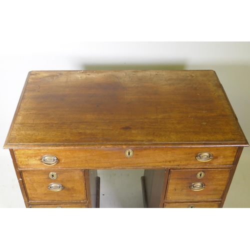 1028 - A Georgian mahogany kneehole desk, the seven drawers with cock beaded detail and original brass plat... 