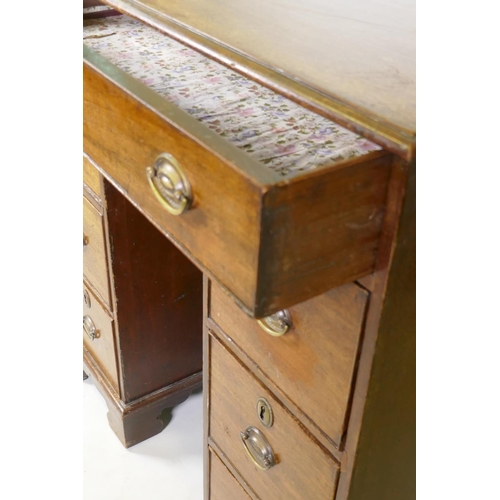 1028 - A Georgian mahogany kneehole desk, the seven drawers with cock beaded detail and original brass plat... 