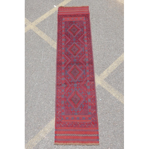 1031 - A red and blue ground hand woven Afghan Meshkin tribal runner, 60 x 240cm