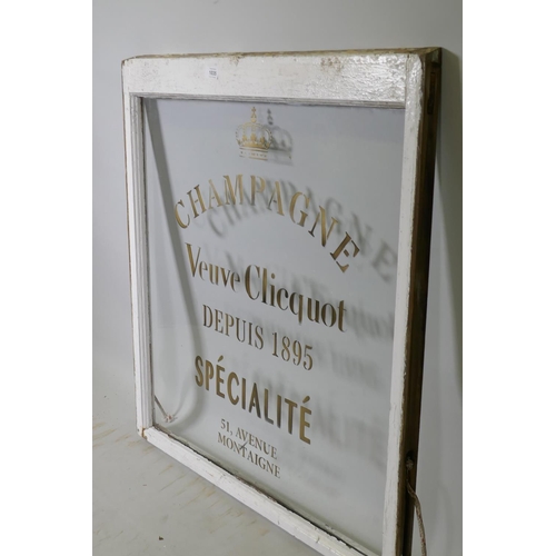 1035 - A painted window frame with later decorative painted signwork, 82 x 88cm