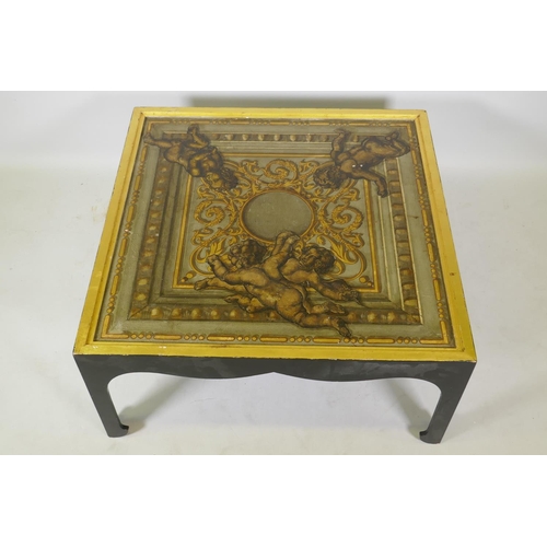 1037 - A low coffee table, the canvassed top with painted and parcel gilt decoration, 87 x 87 x 41cm