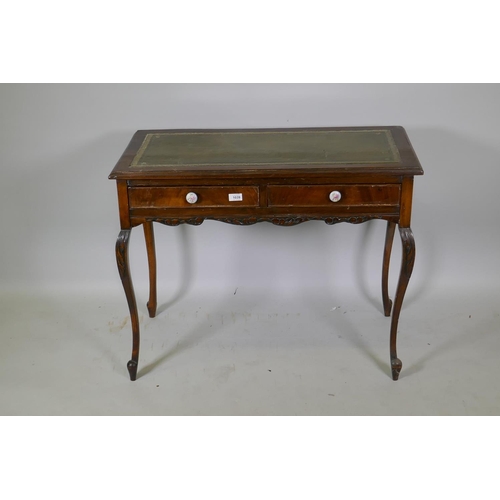 1039 - A Victorian mahogany two drawer writing table, with inset leather top, raised on cabriole supports, ... 