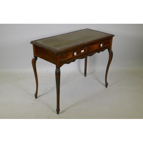 1039 - A Victorian mahogany two drawer writing table, with inset leather top, raised on cabriole supports, ... 