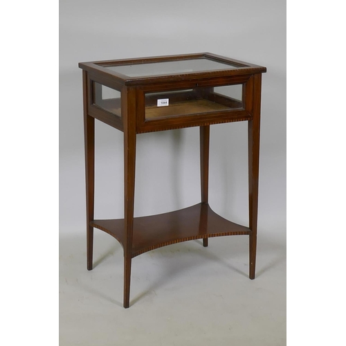 1044 - A Victorian inlaid mahogany bijouterie cabinet, raised on square tapering supports united by a shape... 