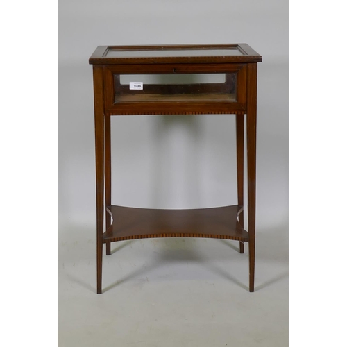 1044 - A Victorian inlaid mahogany bijouterie cabinet, raised on square tapering supports united by a shape... 