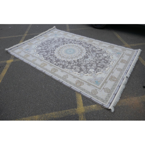 1045 - A fine woven white and pewter ground Iranian carpet embossed with a floral medallion design, 3 x 2m