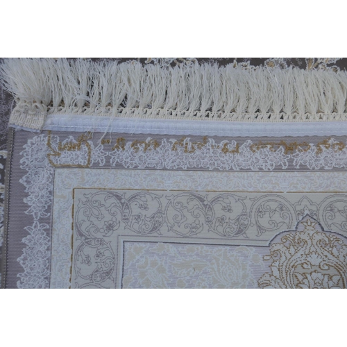 1045 - A fine woven white and pewter ground Iranian carpet embossed with a floral medallion design, 3 x 2m