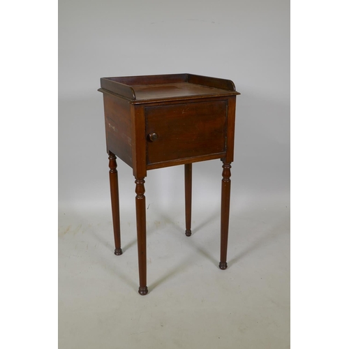 1049 - A Georgian mahogany pot cupboard with three quarter gallery top, raised on turned supports, 42 x 38 ... 