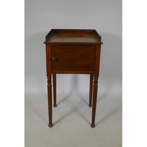 1049 - A Georgian mahogany pot cupboard with three quarter gallery top, raised on turned supports, 42 x 38 ... 