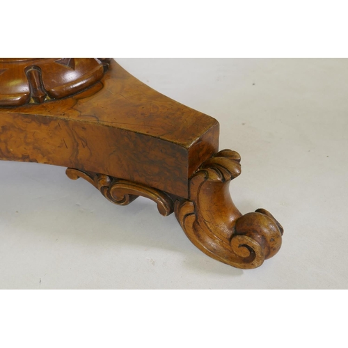 1050 - A 1920s figured walnut piano stool on a triform base, 52cm high