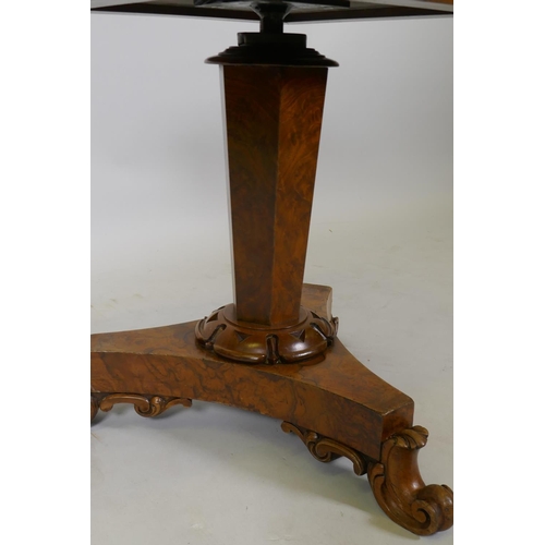 1050 - A 1920s figured walnut piano stool on a triform base, 52cm high