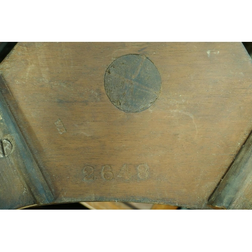 1050 - A 1920s figured walnut piano stool on a triform base, 52cm high