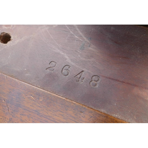 1050 - A 1920s figured walnut piano stool on a triform base, 52cm high