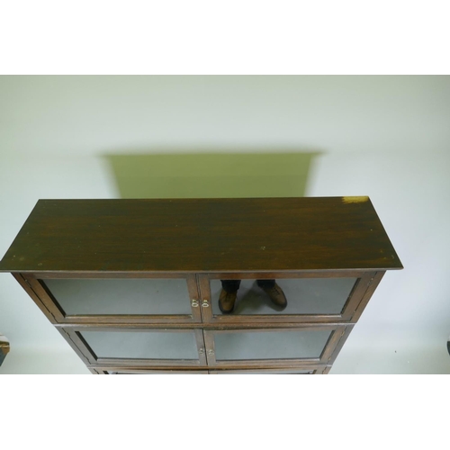 1051 - A 1930s oak two section bookcase, with six glazed doors over a stepped base of two more, 92 x 32 x 1... 