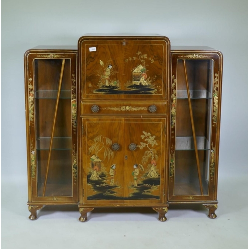 1055 - An Art Deco 'Turnidge' walnut Odeon style display cabinet with raised chinoiserie decoration, the fa... 