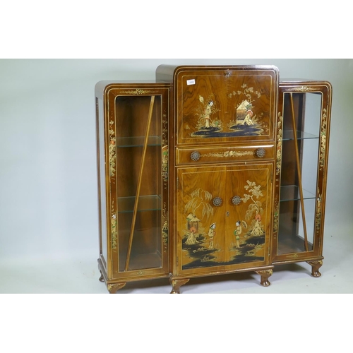 1055 - An Art Deco 'Turnidge' walnut Odeon style display cabinet with raised chinoiserie decoration, the fa... 