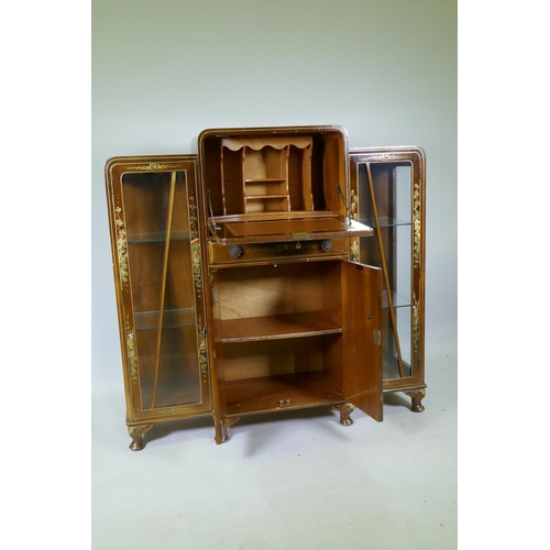 1055 - An Art Deco 'Turnidge' walnut Odeon style display cabinet with raised chinoiserie decoration, the fa... 