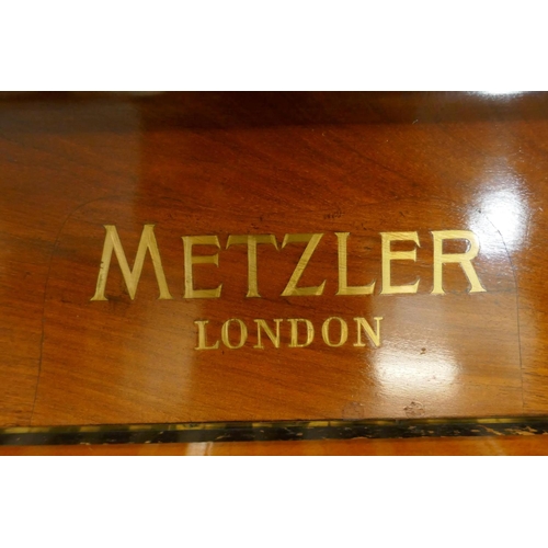 1057 - A Metzler of London walnut cased upright piano with inlaid decoration and brass candle sconces, and ... 