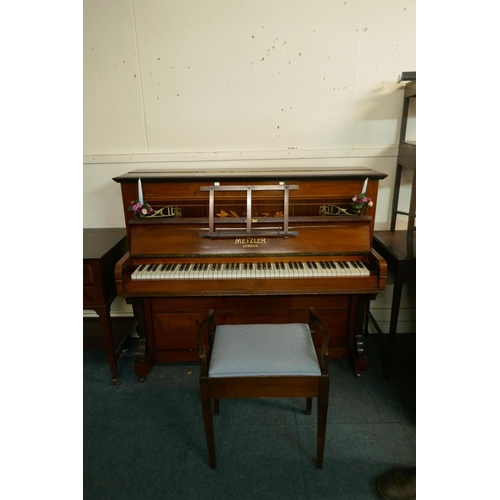 1057 - A Metzler of London walnut cased upright piano with inlaid decoration and brass candle sconces, and ... 