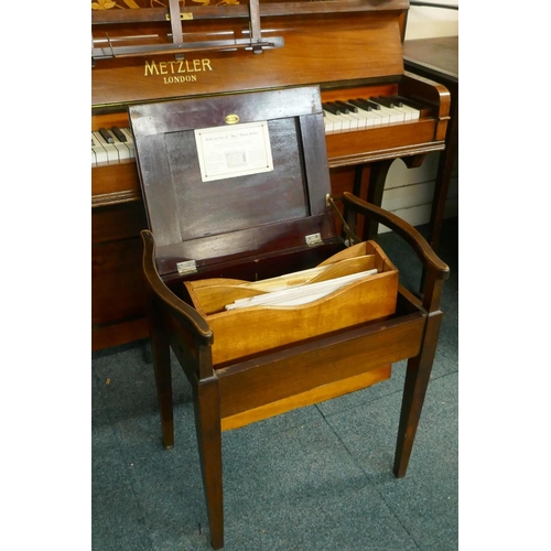 1057 - A Metzler of London walnut cased upright piano with inlaid decoration and brass candle sconces, and ... 