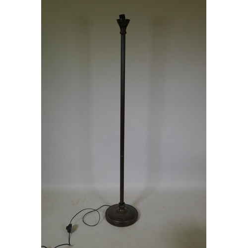 1063 - A fluted metal standard lamp with clouded glass shade, 166cm high