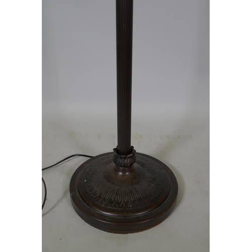 1063 - A fluted metal standard lamp with clouded glass shade, 166cm high