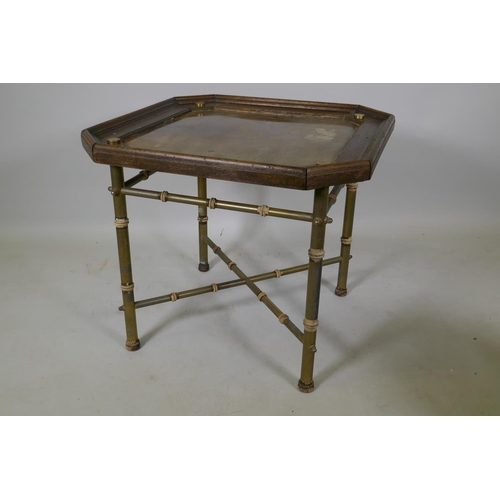 1064 - A coffee table with inset brass top and wood frame, raised on brass base with bamboo style turned mo... 