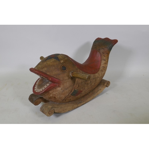 1066 - A carved and painted wood rocking dolphin, 62cm long