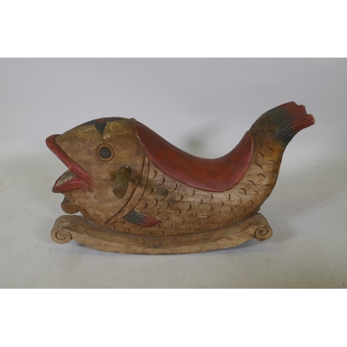 1066 - A carved and painted wood rocking dolphin, 62cm long